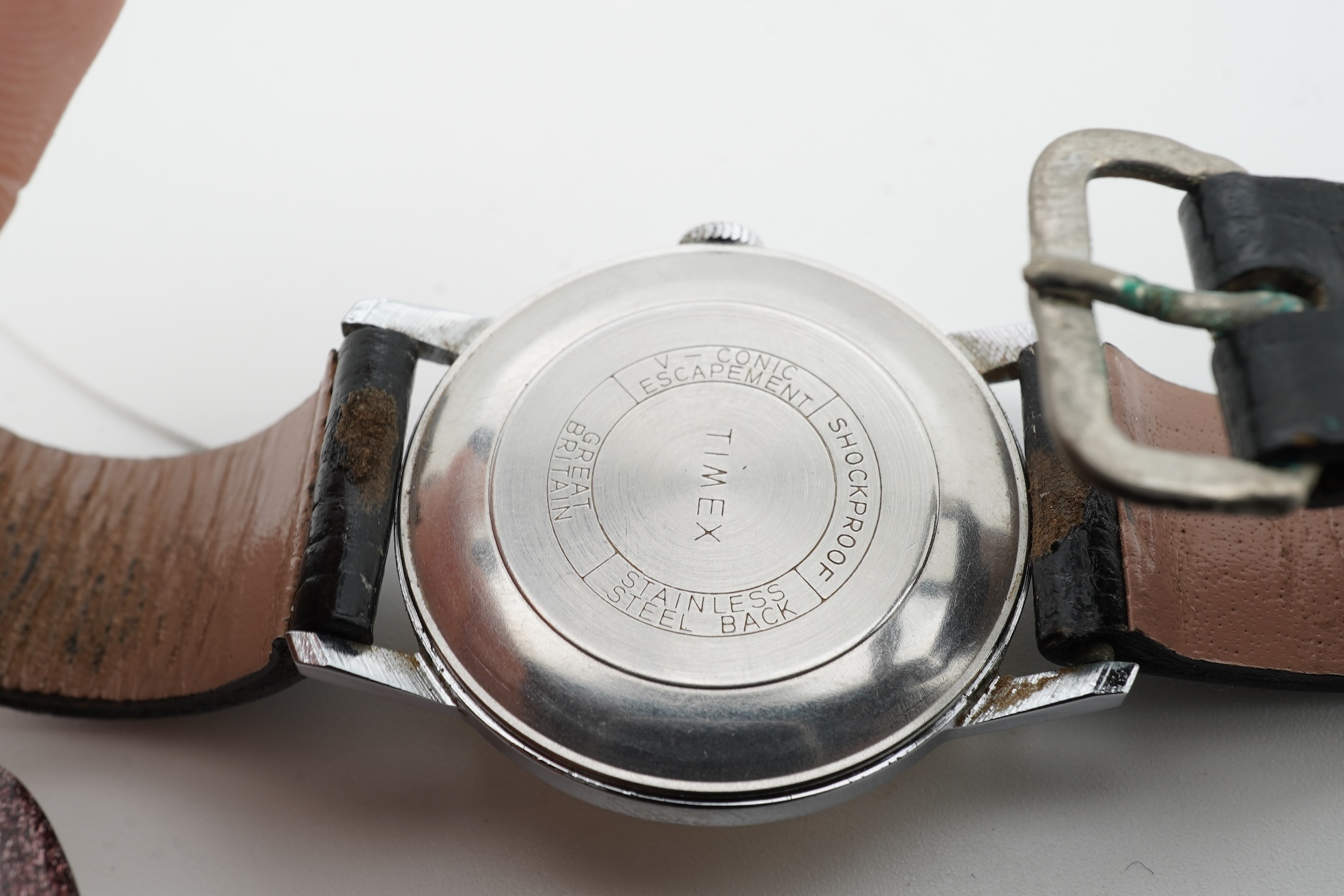 Two 1950s manual wind wrist watches; a gentleman’s stainless steel wristwatch by P. Buhre, retailed by the Goldsmiths & Silversmiths Company Ltd. case diameter 34mm, no strap, together with a Timex watch with box and pap